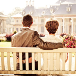 Couple sitting on park bench date