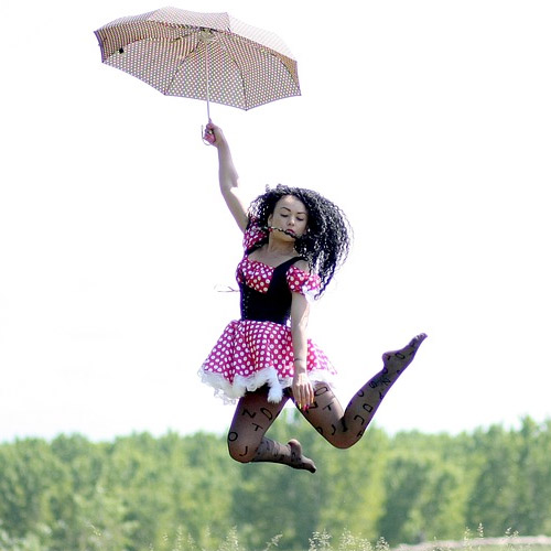 Woman with umbrella jumping